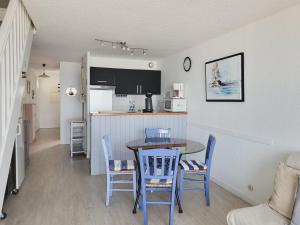a kitchen and dining room with a table and chairs at résidence les oyats in Jullouville-les-Pins +33 photos