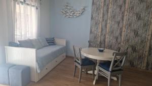 a bedroom with a bed and a table and chairs at Domek v srdci Fara in Faro