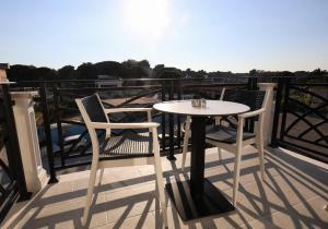 a white table and two chairs on a balcony at LiEl Holiday in Vlorë