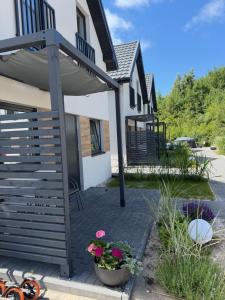 a patio with flowers in a pot next to a house at PORTKNAUBER in Rowy +116 photos