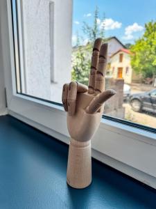 a wooden hand sculpture sitting on a window sill at JUPAS - Premium Apartments in Konz