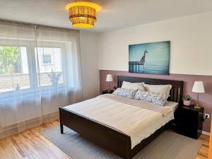 a bedroom with a large bed and a window at JUPAS - Premium Apartments in Konz