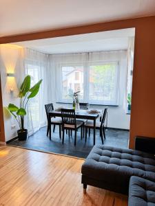 a living room with a dining room table and chairs at JUPAS - Premium Apartments in Konz