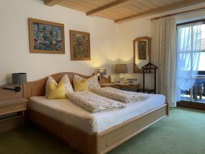 a bedroom with a large bed with yellow pillows at Haus Lukaswinkl in Schönau am Königssee