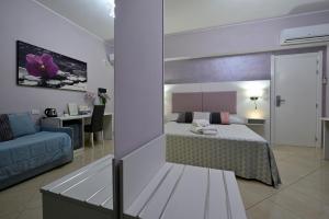 a bedroom with a bed and a couch and a desk at Pepe'Accommodation in Parghelia