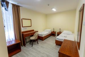 a hospital room with two beds and a desk at Kolegium Nowe PANS - hostel in Przemyśl