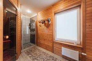 a bathroom with a shower and a window at Zaļais Stūrītis - Semi-Detached Holiday Home with Private entrance & Indoor Sauna in Liepāja +43 photos