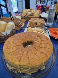 a table with a pie on a table with other foods at Pousada Oceano Azul in Guarapari