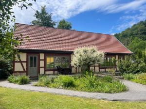 a small house with a red roof at Ferienhaus an der Thyragrotte in Stolberg
