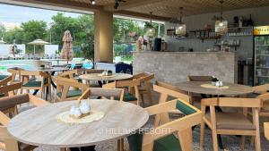 a restaurant with tables and chairs and a pool at HILLIUS Resort in Solotvyno