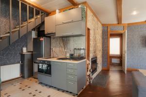 a kitchen with a sink and a stove at Zaļais Stūrītis - Semi-Detached Holiday Home with Private entrance & Indoor Sauna in Liepāja