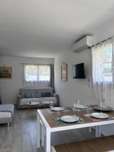 a living room with a table and a couch at Maxima Sunset in Sainte-Maxime
