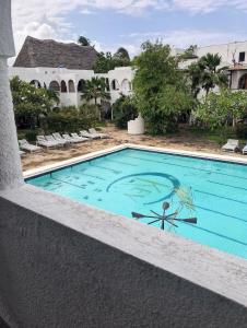 a swimming pool on the side of a resort at Beach front Spacious Studio in Malindi