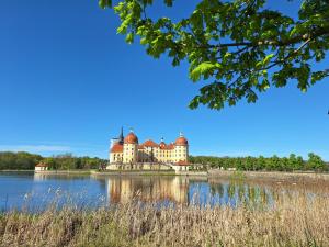 a castle in the middle of a lake at Kleinstadt-Fritz in Radeburg