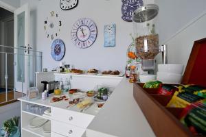 a kitchen with a counter and clocks on the wall at Pepe'Accommodation in Parghelia