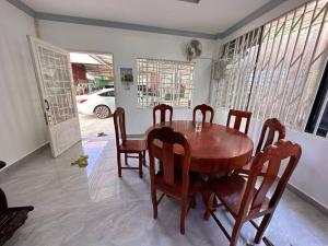 a dining room with a wooden table and chairs at Suman Thapa House in Kathmandu