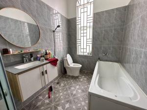 a bathroom with a sink and a tub and a toilet at Suman Thapa House in Kathmandu