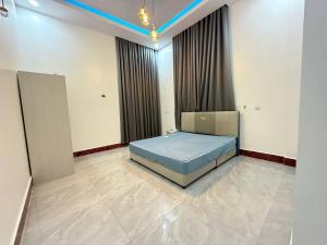 a bedroom with a bed in the middle of a room at Suman Thapa House in Kathmandu