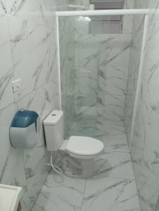a white bathroom with a toilet and a shower at Hostel Brasil Gru in Guarulhos +28 photos