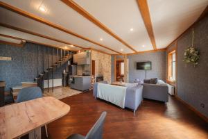 a living room with a couch and a table at Zaļais Stūrītis - Semi-Detached Holiday Home with Private entrance & Indoor Sauna in Liepāja