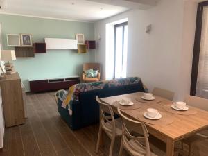 a living room with a table and a couch at Casa vacanza Gea - Superior Apartment in Bergamo city with private parking car in Bergamo