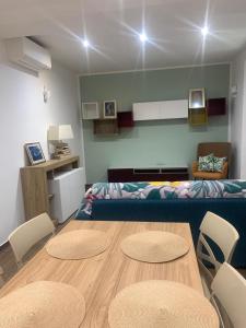 a living room with a table and chairs and a couch at Casa vacanza Gea - Superior Apartment in Bergamo city with private parking car in Bergamo