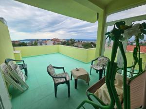 a balcony with chairs and a table and a view at Paralax Hotel in Varna City