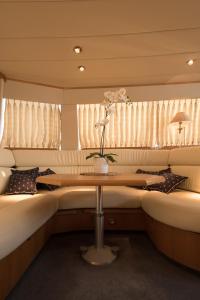 a room with two beds and a table with a flower at Solymar Greece Yachting. m/y "LL" in Athens