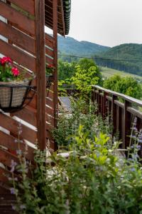 a balcony with flowers on the side of a house at Cudne Manowce in Wisła +71 photos