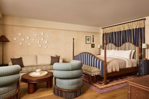 a bedroom with a bed and a couch and chairs at Faraway Sag Harbor in Sag Harbor +52 photos