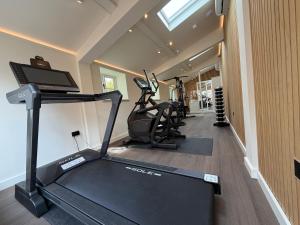 a gym with several treadmills and a treadmill at Meadow View House at Pudleston Court in Docklow