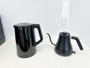 a black appliance sitting on a counter next to an electrical outlet at ヴィラ砂時計超豪華大型貸切別荘九十九里海歩3分寝室5つペット可サウナ本格カラオケグランドピアノ全自動麻雀bbq焚き火 in Kujukuri