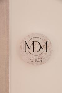 a sign that says mum on a white wall at MaDaM Essence in Nei Poroi