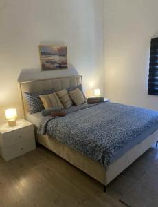 a bedroom with a bed with two lamps on it at Villa Klara in Gedići