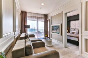 a living room with a couch and a bed at Azure Coast Deluxe Residence - Budva Seafront Living Suites in Bečići