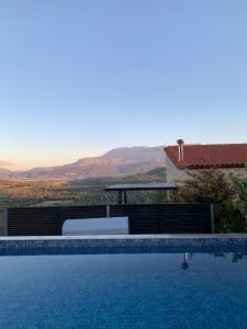 a swimming pool in front of a house at Villa Gamma Kreta in Kamilari