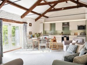 a kitchen and living room with a table and chairs at Trevadlock Manor by Smart Welcomes in Launceston