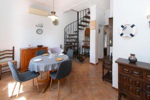 a dining room with a table and chairs and a staircase at WELCS CASA 357 EMP con piscina privada in Empuriabrava