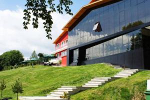 a large building with stairs in front of a building at Семеен хотел Forest Retreat Mountain Resort in Kyustendil