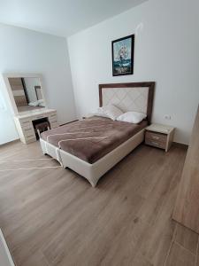 a bedroom with a large bed and a wooden floor at Sunshine view in Seoca +22 photos