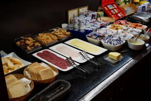 a buffet with different types of food on a table at Hotel Lent in Maribor +17 photos