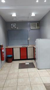 a kitchen with a chalkboard and a refrigerator in a room at مساكن صفوه الديار in Abha