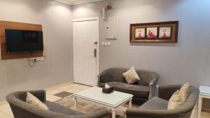 a living room with two couches and a tv at مساكن صفوه الديار in Abha