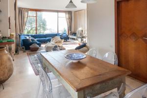 a living room with a wooden table and chairs at Welcome Traveller VILLA LEDA in Garda