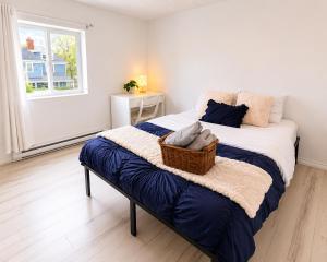 a bedroom with a bed with a basket on it at Màple room & Aurora House in Glace Bay