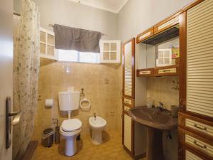 a small bathroom with a toilet and a sink at Akisol Hostel Idanha in Idanha-a-Nova +48 photos