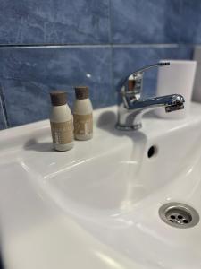 two bottles ofodorizers sitting on a bathroom sink at Vila Cristina in Mamaia Sat/Năvodari