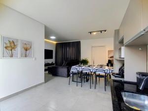 a dining room with a table and some chairs at Sobrado Matinhos 480 m da praia l novo l central 3quartos in Matinhos