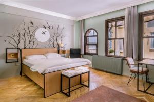 a bedroom with a bed with a tree mural on the wall at YOLO Hostel in Istanbul +38 photos