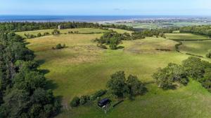 an overhead view of a green field with trees at Castor in Abergele
